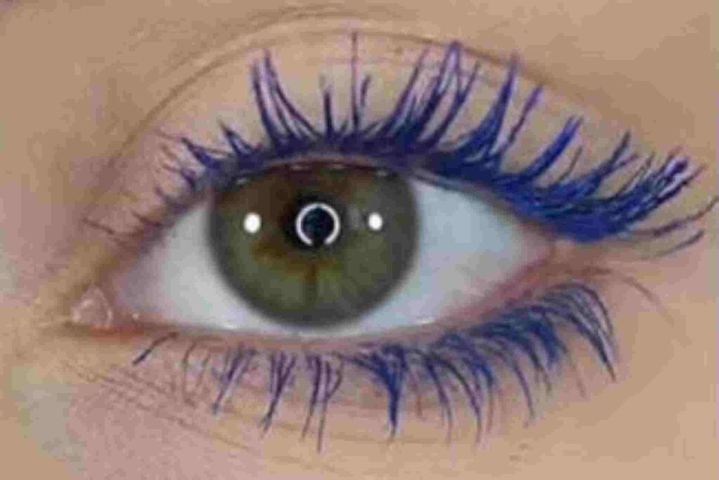Green eye with blue mascara