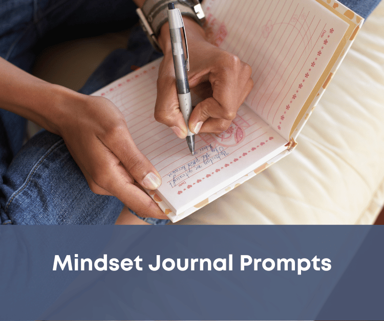 Someone writing prompts in their mindset journal